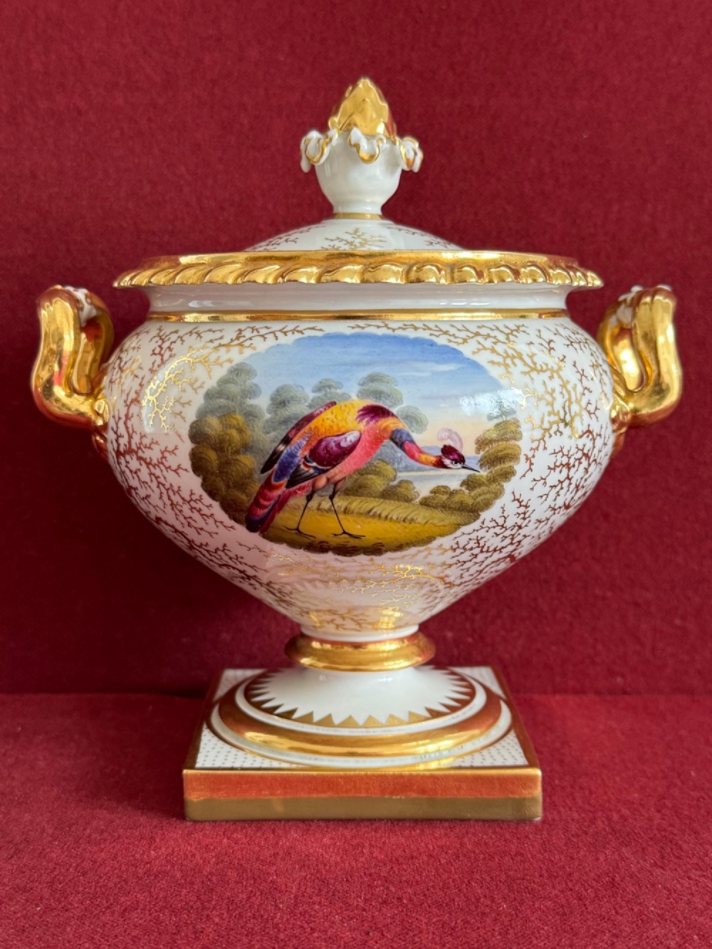 A pair of Regency Flight, Barr & Barr Worcester porcelain cream tureens featuring hand-painted exotic bird panels, elaborate gilding, twin scroll handles, and square plinth bases. View X