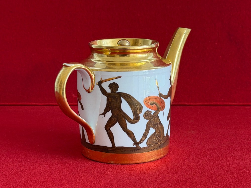 A Regency cylindrical porcelain teapot featuring a gilded spout and collar alongside hand-painted classical figures on a white ground. View VI
