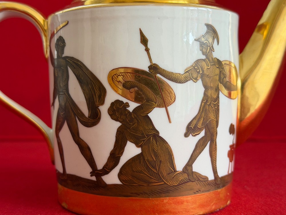 A Regency cylindrical porcelain teapot featuring a gilded spout and collar alongside hand-painted classical figures on a white ground. View VIII