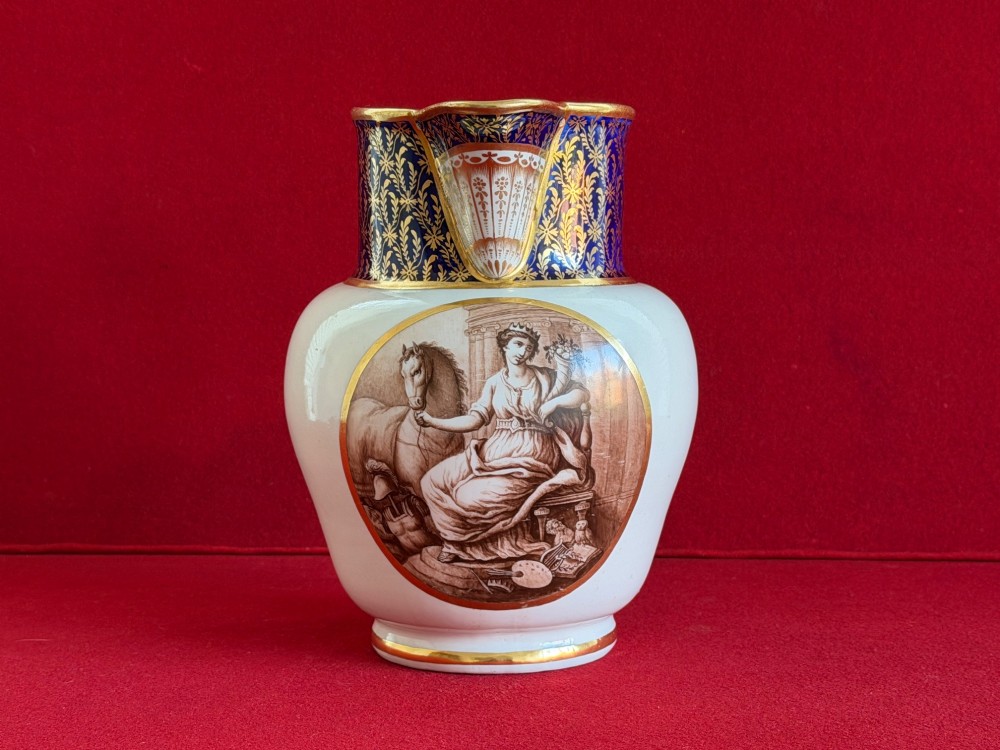An eighteenth-century Flight and Barr Worcester porcelain jug decorated with a cobalt blue gilded collar and a sepia painted classical panel.
