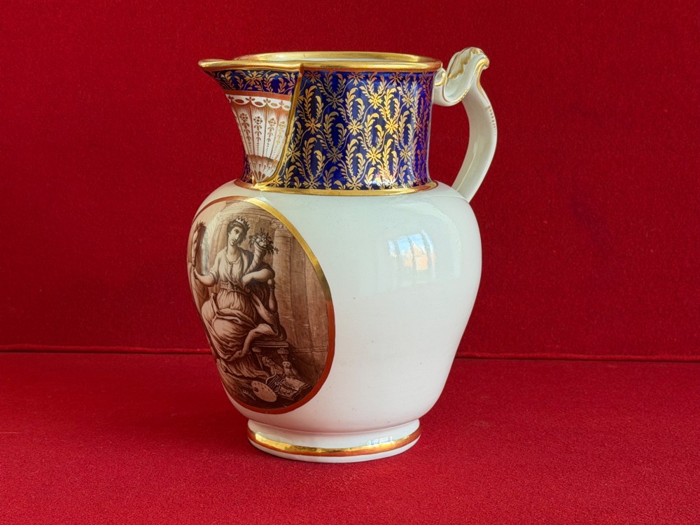 An eighteenth-century Flight and Barr Worcester porcelain jug decorated with a cobalt blue gilded collar and a sepia painted classical panel. View II