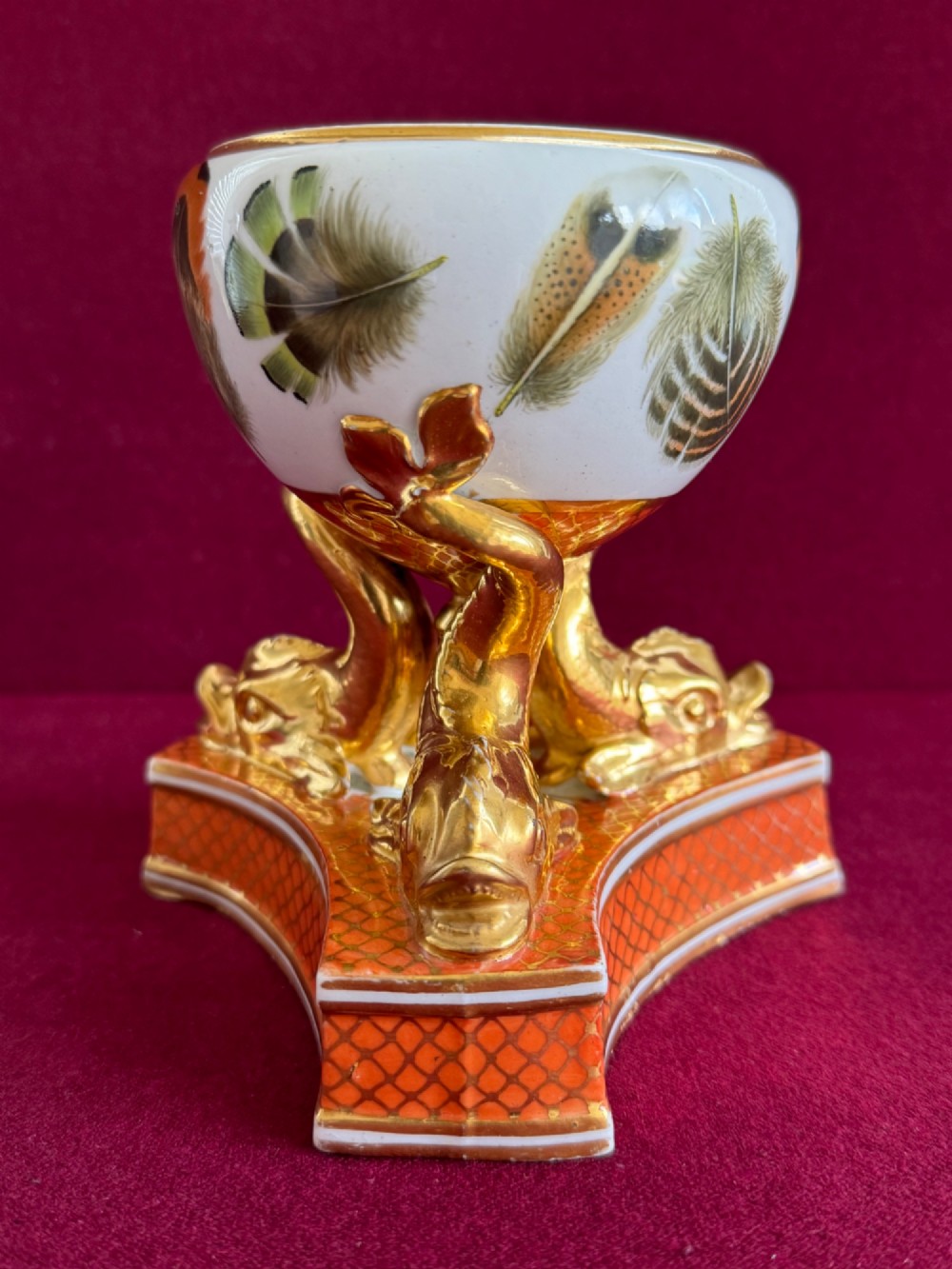 A nineteenth-century Chamberlain Worcester porcelain pastille burner with hand-painted feathers on a white bowl supported by gilt dolphins. View VI