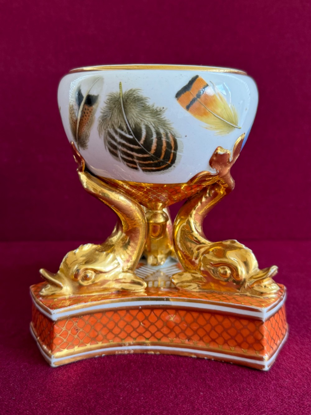 A nineteenth-century Chamberlain Worcester porcelain pastille burner with hand-painted feathers on a white bowl supported by gilt dolphins. View VII