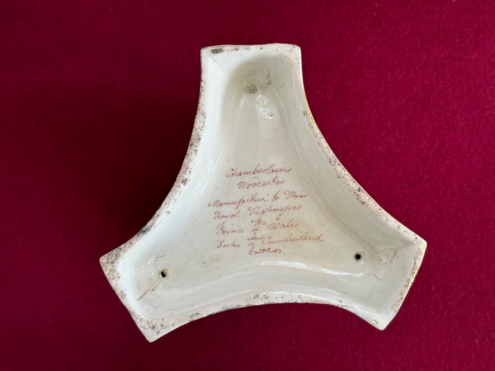 A nineteenth-century Chamberlain Worcester porcelain pastille burner with hand-painted feathers on a white bowl supported by gilt dolphins. View IX