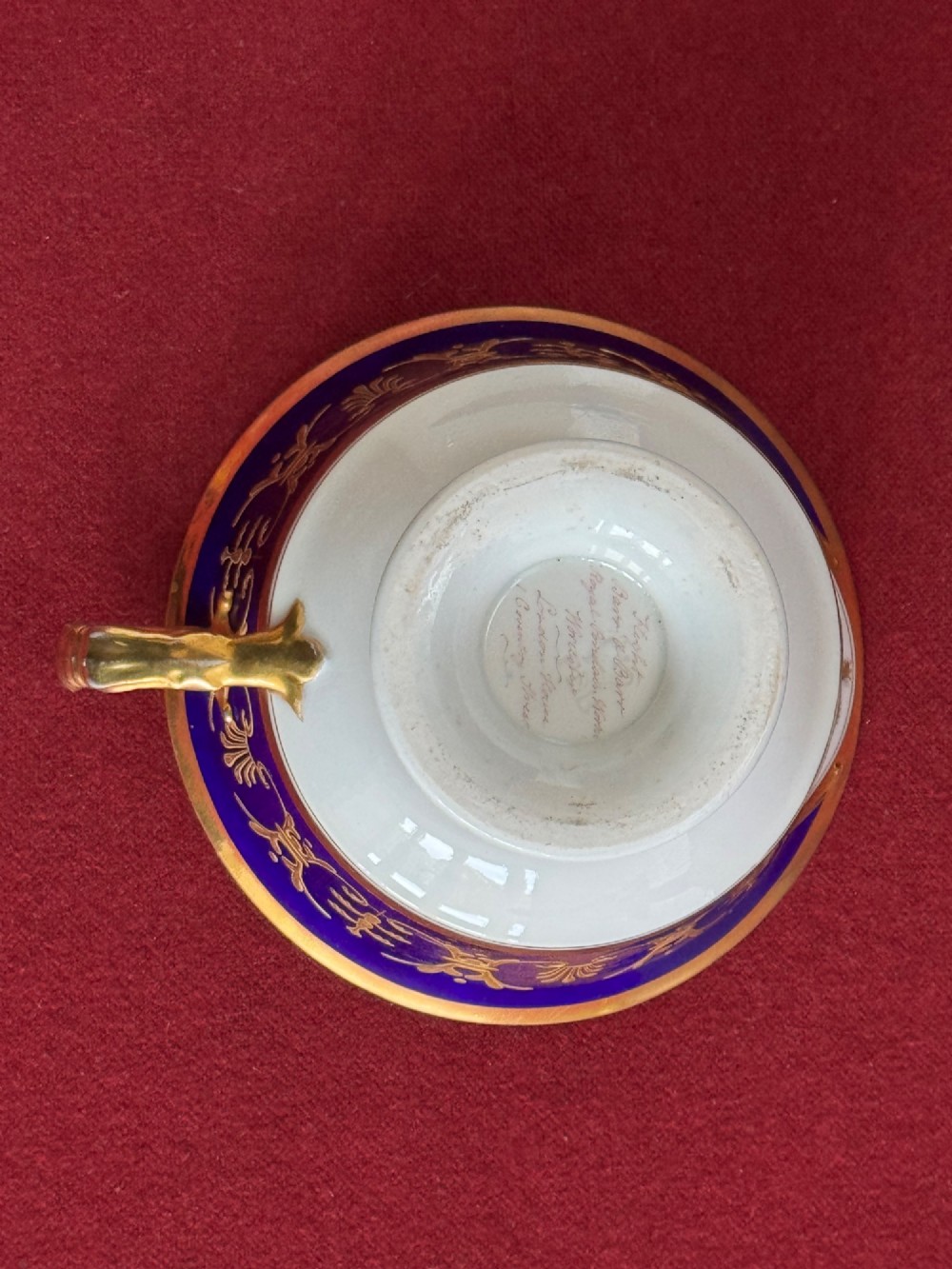 A Regency Flight, Barr and Barr Worcester porcelain cup and saucer featuring a deep cobalt blue border with intricate gold gilding and a central royal armorial crest. View XII