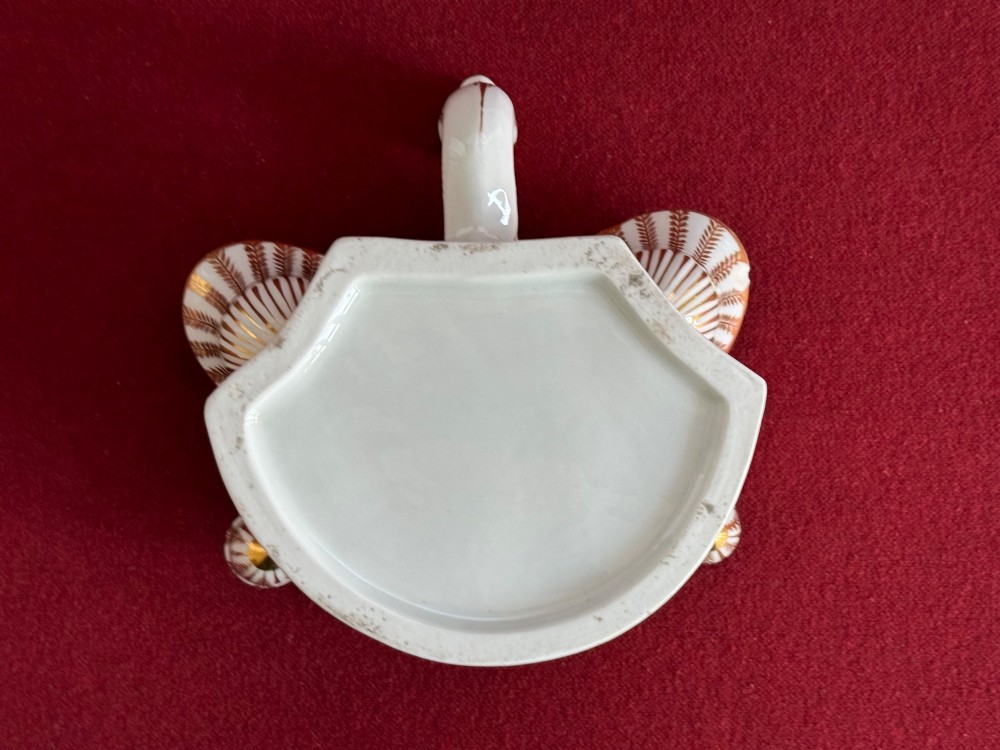 A Regency Flight & Barr Worcester porcelain inkstand painted with realistic seashell panels, gilded borders, quill holders, and a central candlestick. View VI