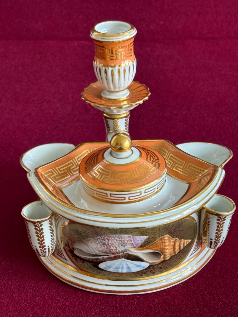 A Regency Flight & Barr Worcester porcelain inkstand painted with realistic seashell panels, gilded borders, quill holders, and a central candlestick. View IX