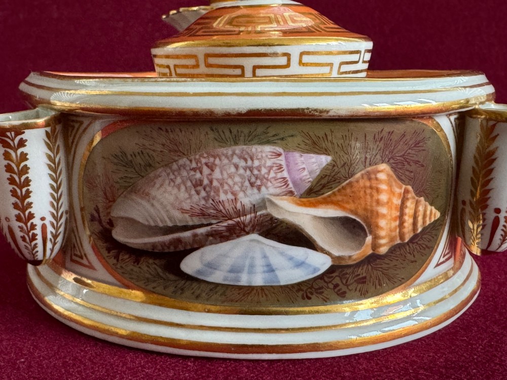 A Regency Flight & Barr Worcester porcelain inkstand painted with realistic seashell panels, gilded borders, quill holders, and a central candlestick. View X