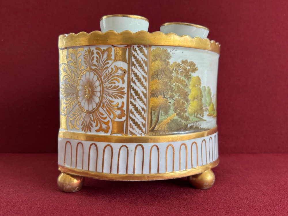 An antique Georgian porcelain bough pot decorated with a hand-painted landscape panel, gilded geometric scroll patterns, arch motifs, and gilt ball feet. View II
