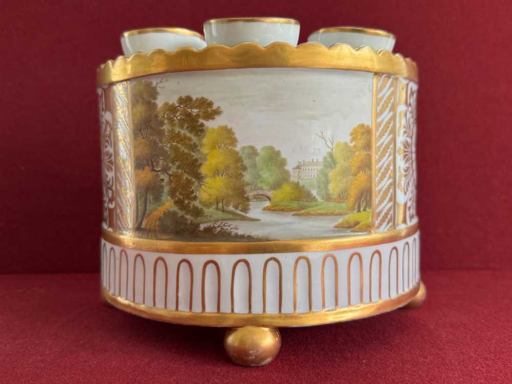 An antique Georgian porcelain bough pot decorated with a hand-painted landscape panel, gilded geometric scroll patterns, arch motifs, and gilt ball feet. View IV