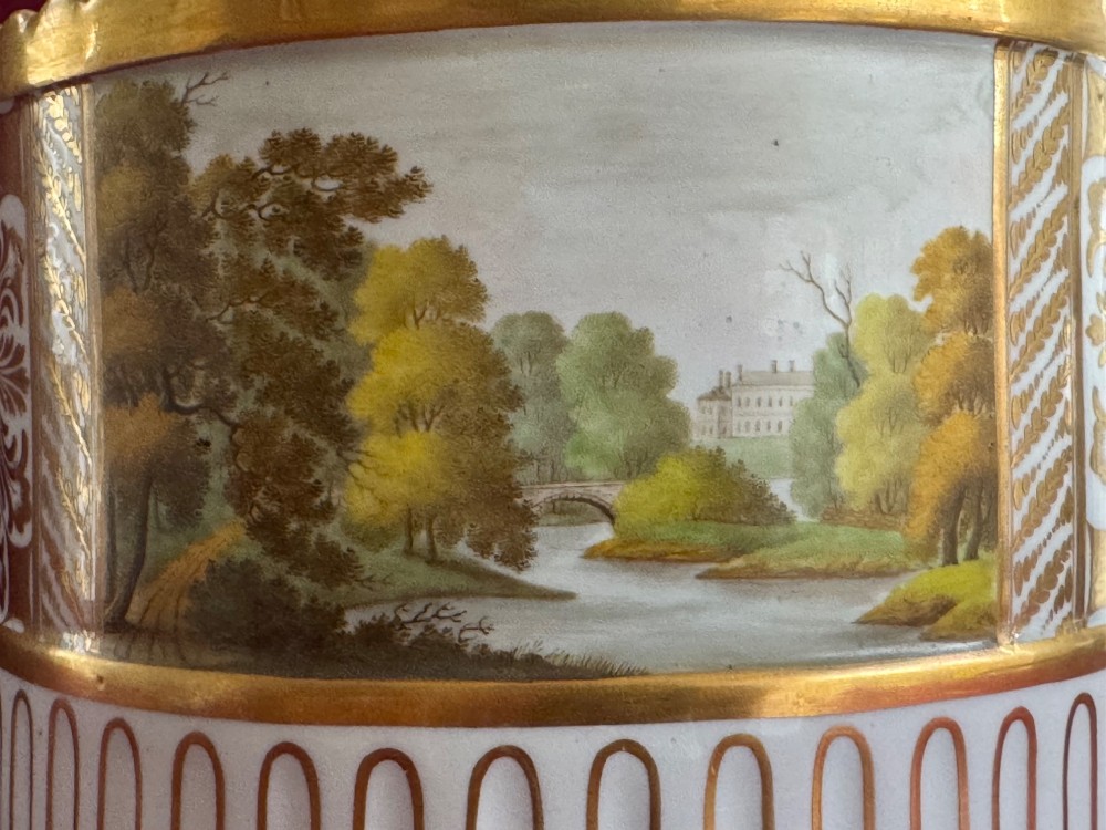 An antique Georgian porcelain bough pot decorated with a hand-painted landscape panel, gilded geometric scroll patterns, arch motifs, and gilt ball feet. View VIII