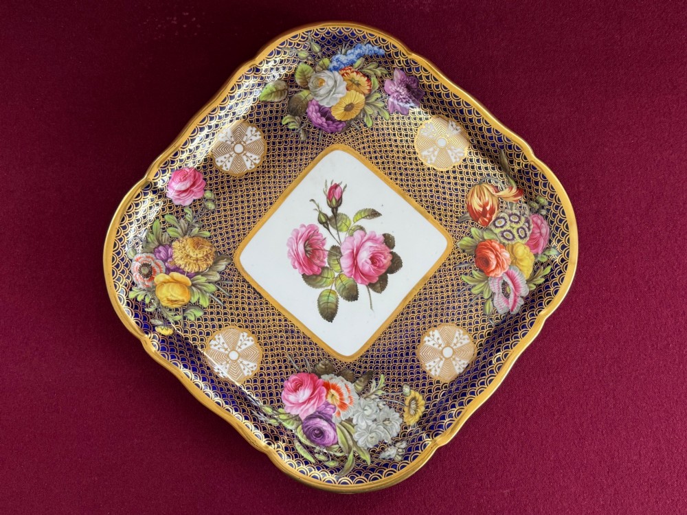 A square Regency porcelain tray featuring hand-painted floral bouquets, an intricate gilt scale pattern over a cobalt blue ground, and a central white reserve with pink roses. View VII