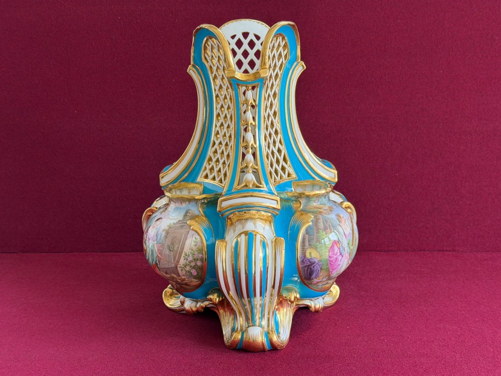 A Victorian Minton porcelain Sevres style vase featuring vibrant turquoise bleu celeste glaze, a reticulated lattice back, gilded Rococo scroll mouldings, and a hand-painted central pastoral scene. View IX