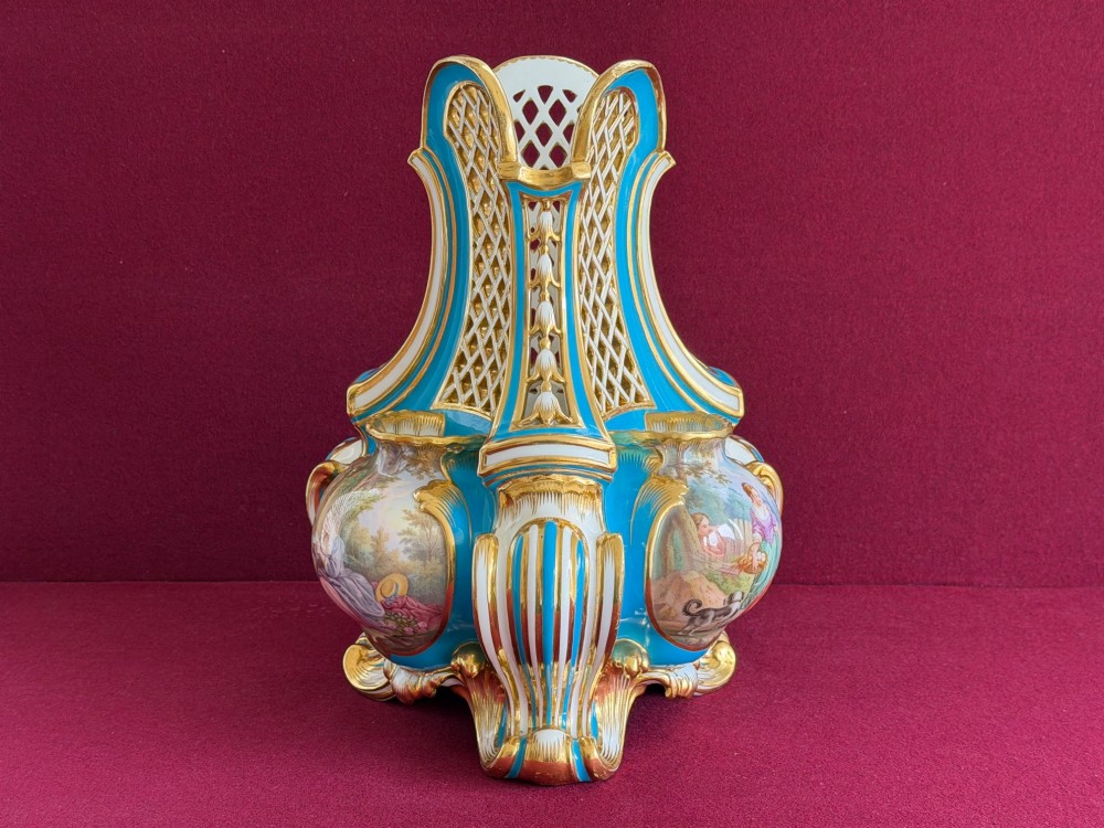 A Victorian Minton porcelain Sevres style vase featuring vibrant turquoise bleu celeste glaze, a reticulated lattice back, gilded Rococo scroll mouldings, and a hand-painted central pastoral scene. View X