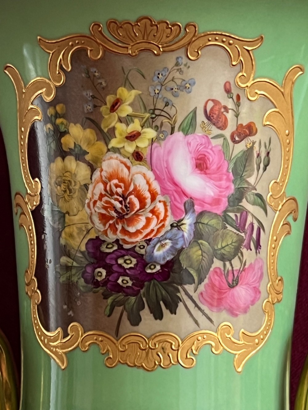 A Flight, Barr & Barr Worcester porcelain Campana shape vase featuring an apple green ground, floral enamel painting, gilt twin handles, and a square base. View IV