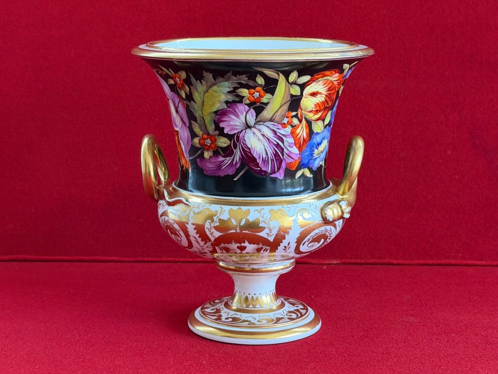 A Regency Derby porcelain campana-shaped urn decorated with hand-painted pink roses on a black ground, featuring gilded handles and neoclassical lower gilding. View III