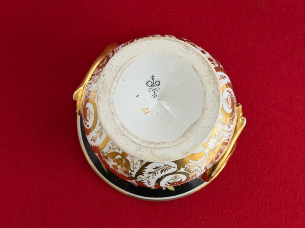 A Regency Derby porcelain campana-shaped urn decorated with hand-painted pink roses on a black ground, featuring gilded handles and neoclassical lower gilding. View V