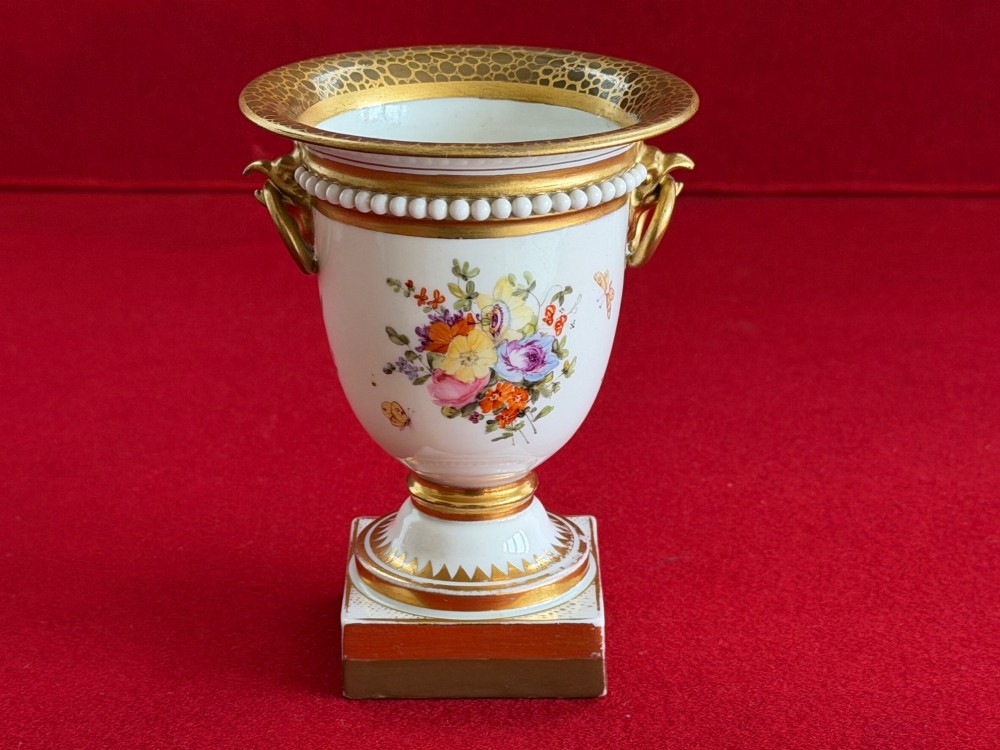 A Regency Flight, Barr and Barr Worcester porcelain campana vase featuring hand-painted floral sprays, gilded handles, a beaded rim, and a square plinth base. View III
