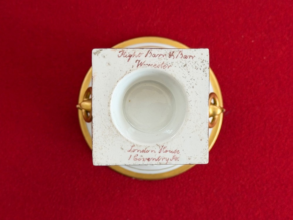 A Regency Flight, Barr and Barr Worcester porcelain campana vase featuring hand-painted floral sprays, gilded handles, a beaded rim, and a square plinth base. View V