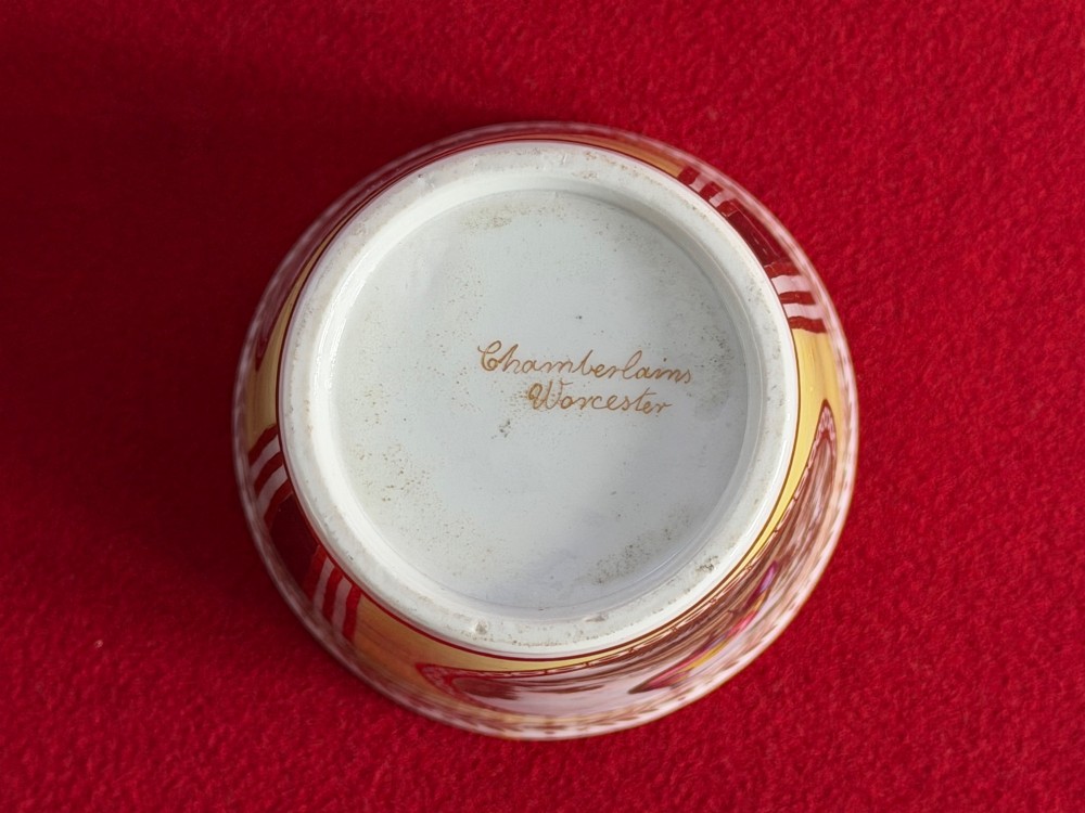 A pair of yellow antique porcelain beakers featuring hand-painted exotic birds within oval gilt reserves and gilded leaf borders along the top rim. View IV