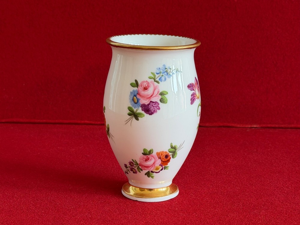 A white porcelain spill vase featuring hand-painted floral sprays, a flared lip, and gilded accent bands along the rim and base. View II