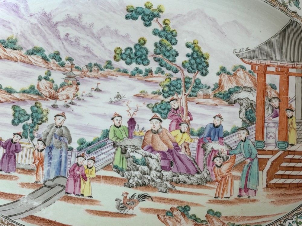An oval Coalport porcelain meat platter decorated with hand-painted oriental figures in a landscape surrounded by a floral and gilded border. View II