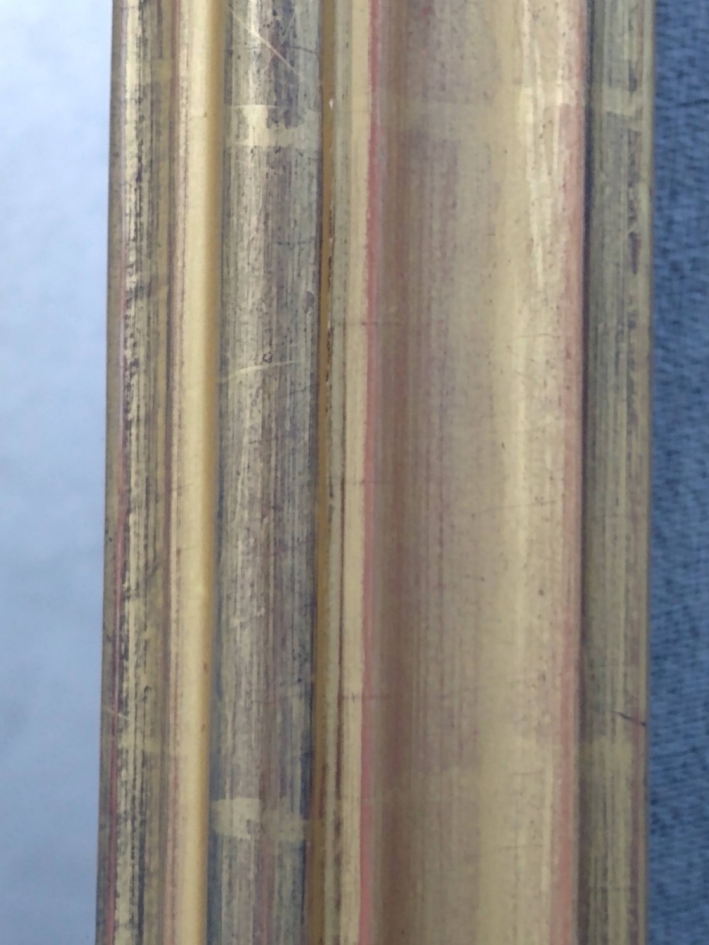A rectangular Victorian overmantel mirror featuring a gilt frame with side scroll brackets and shaped upper inner corners. View II