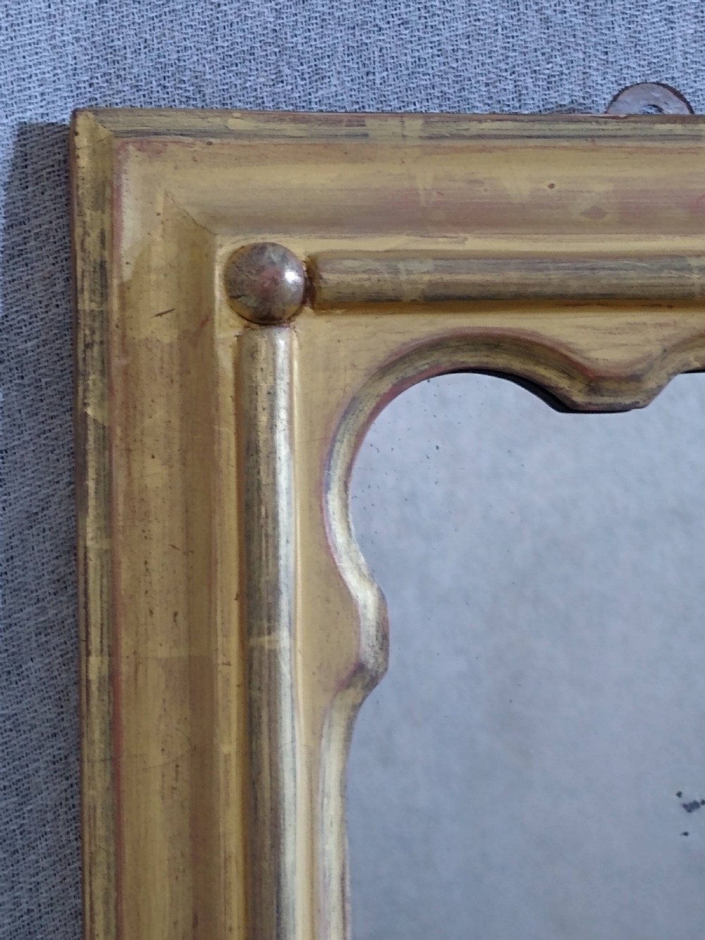 A rectangular Victorian overmantel mirror featuring a gilt frame with side scroll brackets and shaped upper inner corners. View VII