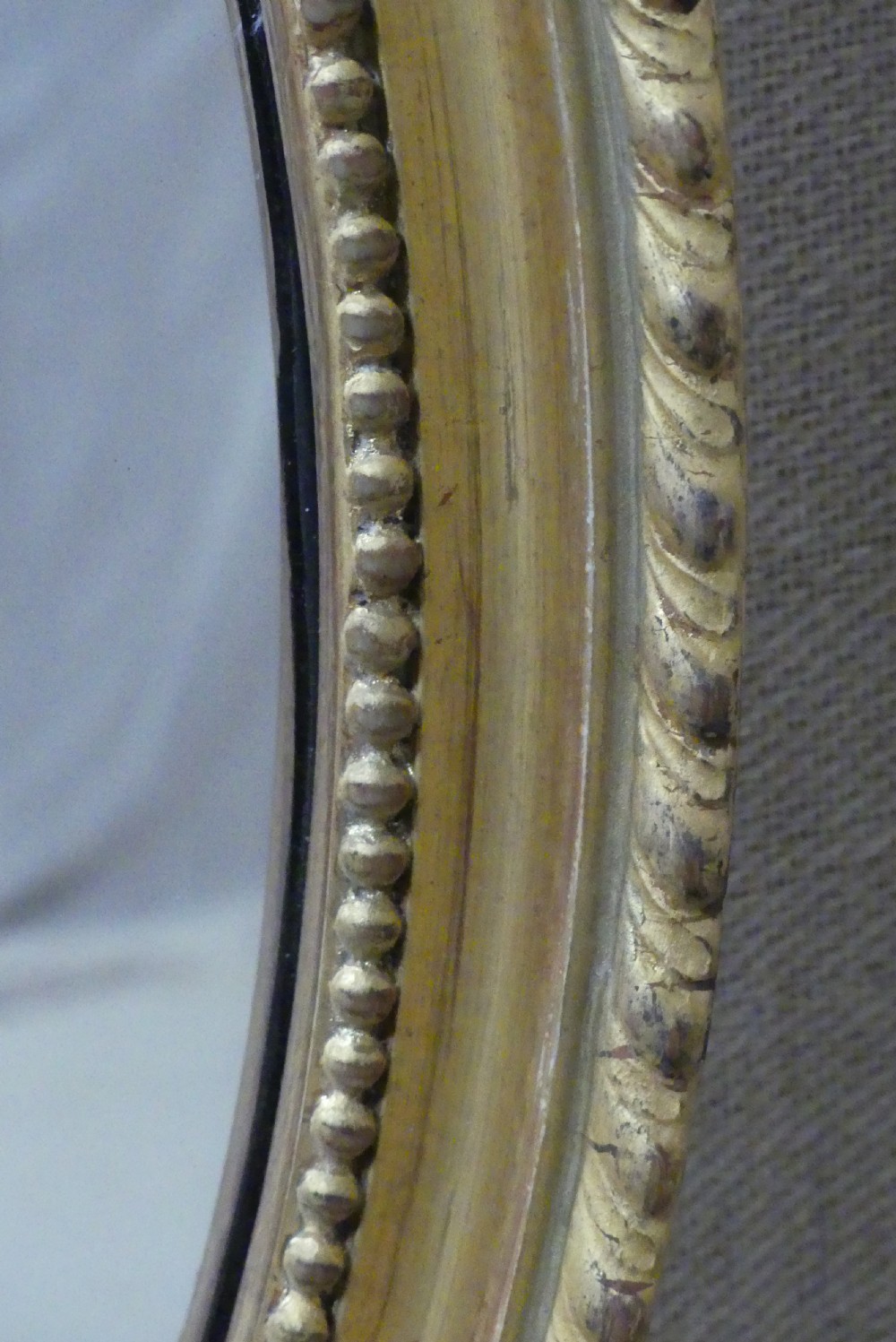 A pair of matching late 19th-century oval mirrors featuring gilded timber frames with beaded edge moulding. View III