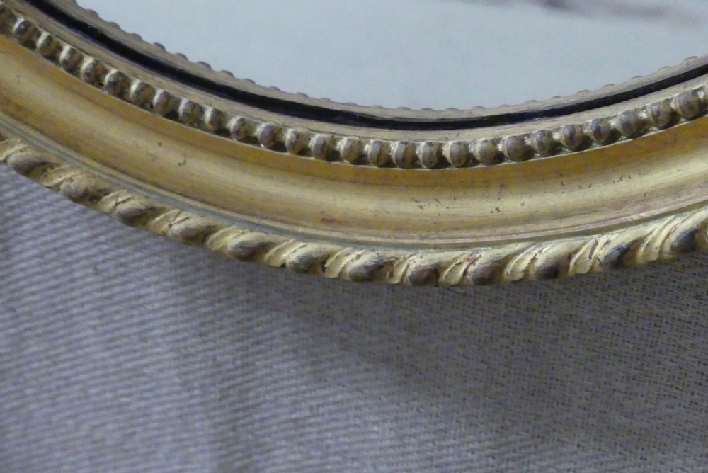 A pair of matching late 19th-century oval mirrors featuring gilded timber frames with beaded edge moulding. View IV