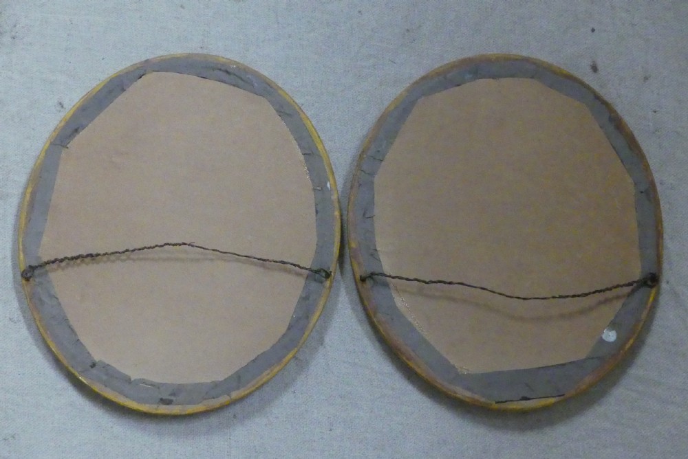 A pair of matching late 19th-century oval mirrors featuring gilded timber frames with beaded edge moulding. View V