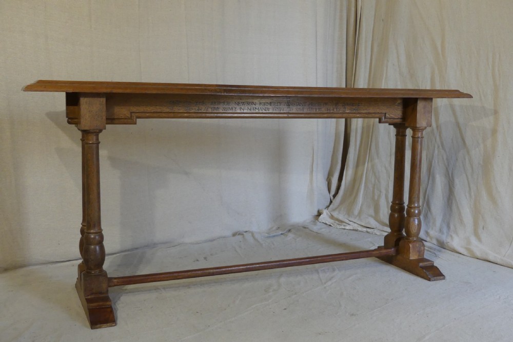 A long, narrow antique oak console table featuring a carved frieze, turned end supports, and a low central stretcher. View II