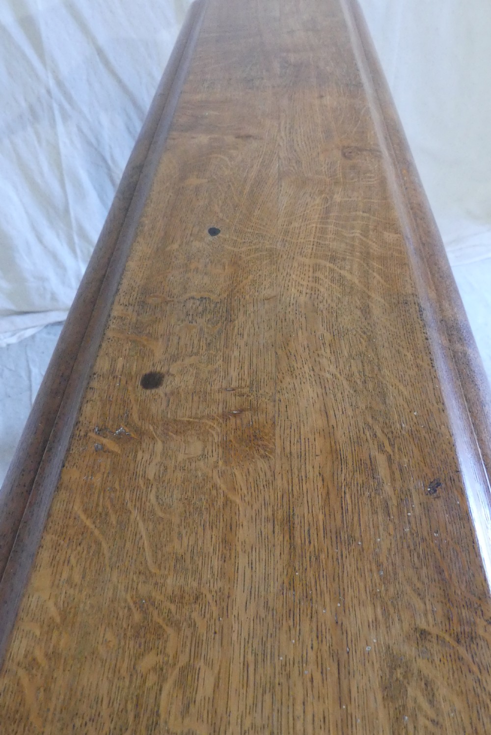 A long, narrow antique oak console table featuring a carved frieze, turned end supports, and a low central stretcher. View VIII