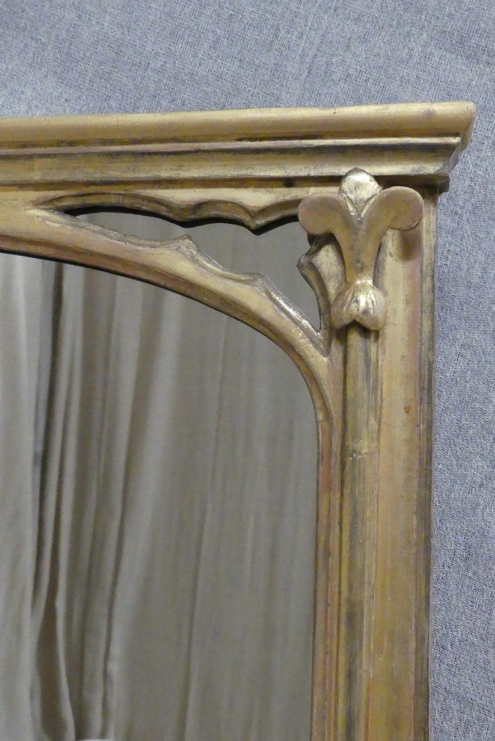 A large late 19th-century rectangular giltwood overmantel mirror featuring an arched inner frame with spandrel detailing. View II