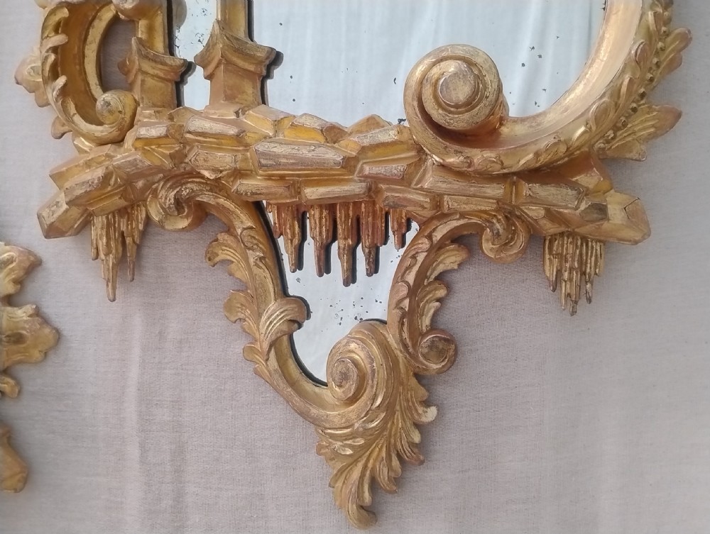 A pair of late 19th-century Chippendale Revival giltwood wall mirrors featuring ornate Rococo C-scrolls, foliage, and icicle carving. View IV