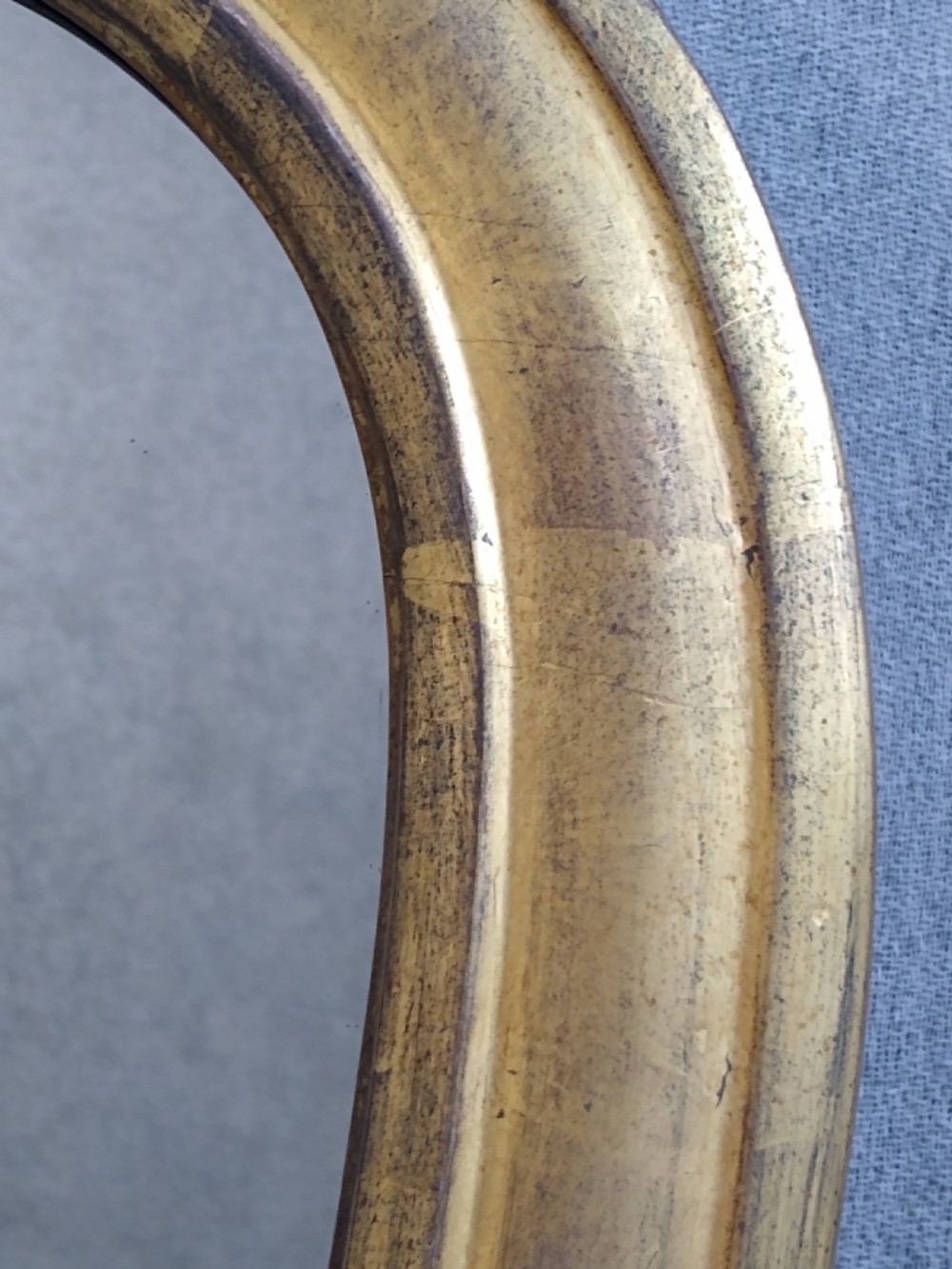 A large Victorian giltwood overmantel mirror featuring an arched top frame moulding and carved acanthus leaf scroll embellishments at the lower base corners. View III