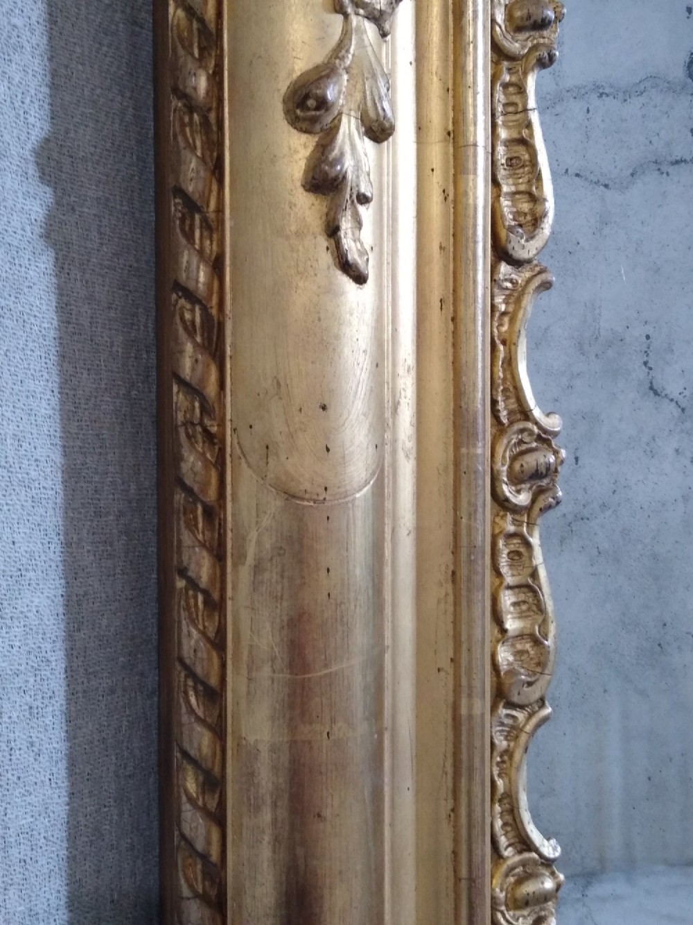 A large rectangular 19th-century French overmantel mirror featuring an ornate gold giltwood frame with detailed foliate and floral moulding. View V