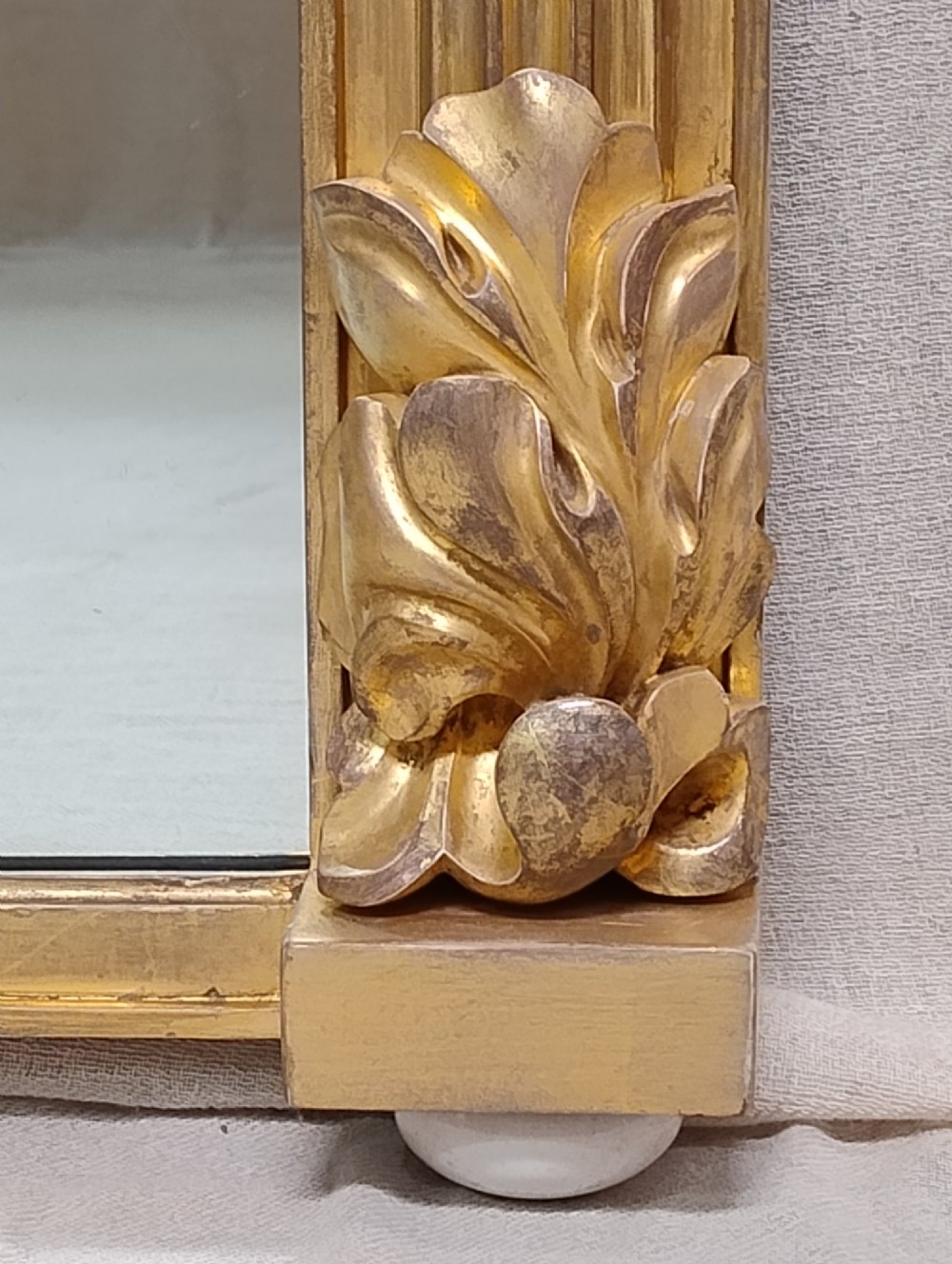 A large nineteenth-century giltwood overmantel mirror featuring carved acanthus leaf cresting and fluted column pilasters. View III