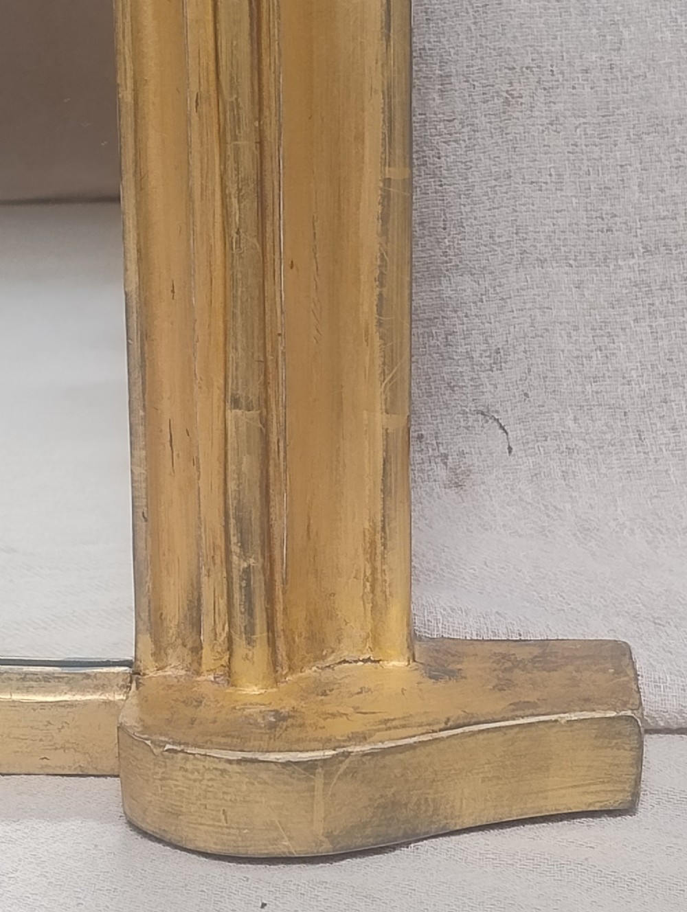 An antique Victorian arched overmantel mirror featuring a moulded gold giltwood frame with subtle bottom side corbels. View III