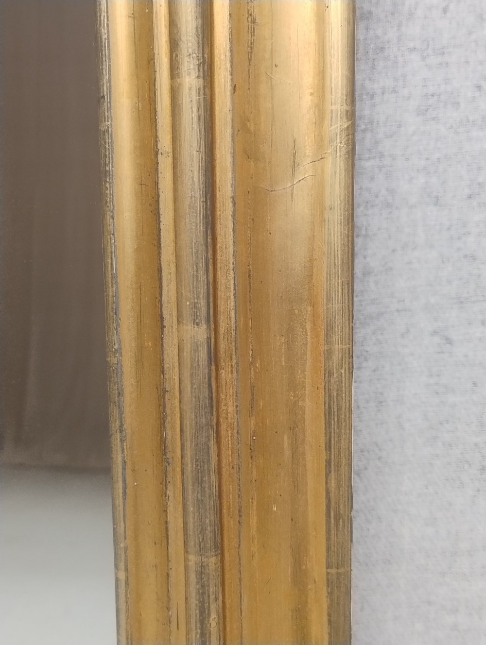 An antique Victorian arched overmantel mirror featuring a moulded gold giltwood frame with subtle bottom side corbels. View IV