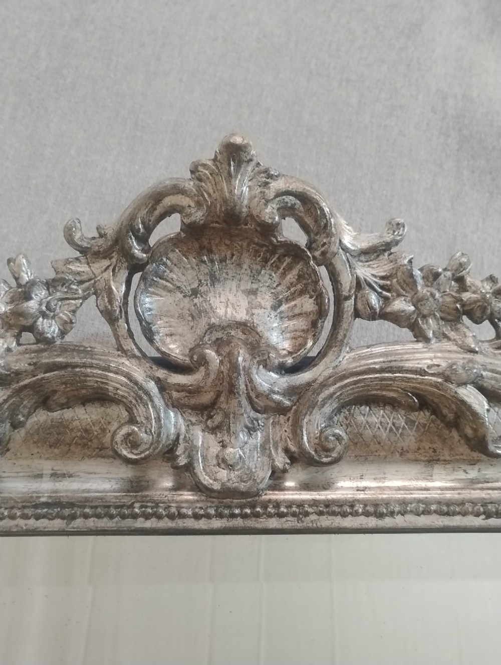 A large nineteenth-century French wall mirror featuring a silver gilt wooden frame, rounded top corners, beaded inner border, and an ornate carved shell crest. View III