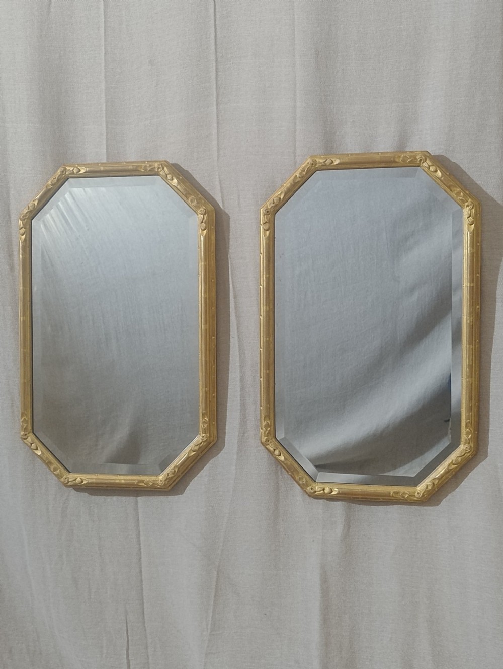 A pair of octagonal Edwardian wall mirrors with water-gilded frames and bevelled glass.