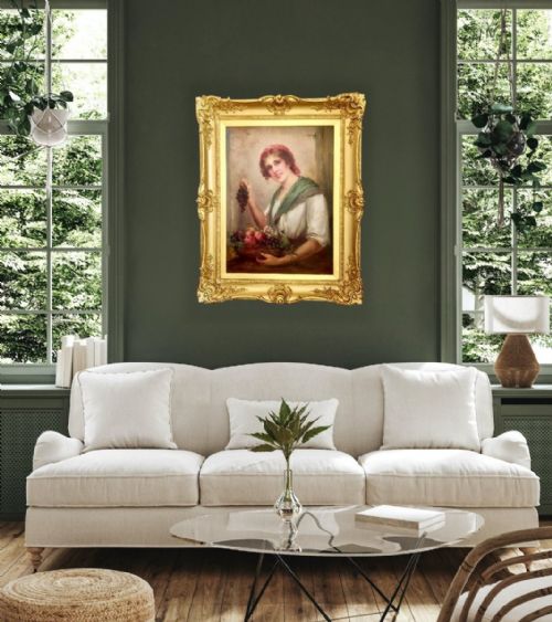 fig 2. An antique oil painting depicting a young woman with a red headscarf holding grapes above a fruit basket, presented in an ornate gold giltwood frame.