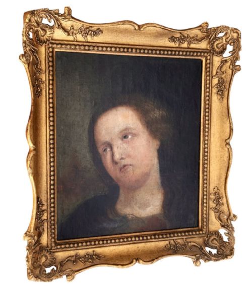 fig 3. An oil painting depicting a head and shoulders portrait of a female figure looking upward, set within an ornate carved giltwood frame.