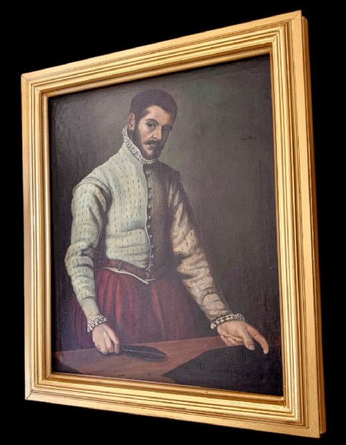 fig 1. A framed oil painting depicting a bearded gentleman tailor in Renaissance attire standing at a cutting table, enclosed in a gilded wooden frame.