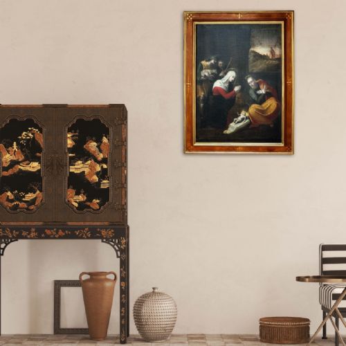 fig 3. An antique oil painting depicting the Adoration of the Shepherds with Mary, Joseph, and the infant Jesus in an inlaid wood frame.