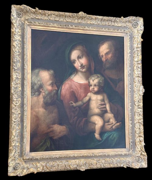 fig 3. An antique oil painting depicting the Holy Family with Saint Jerome set within an ornate carved gilded frame.