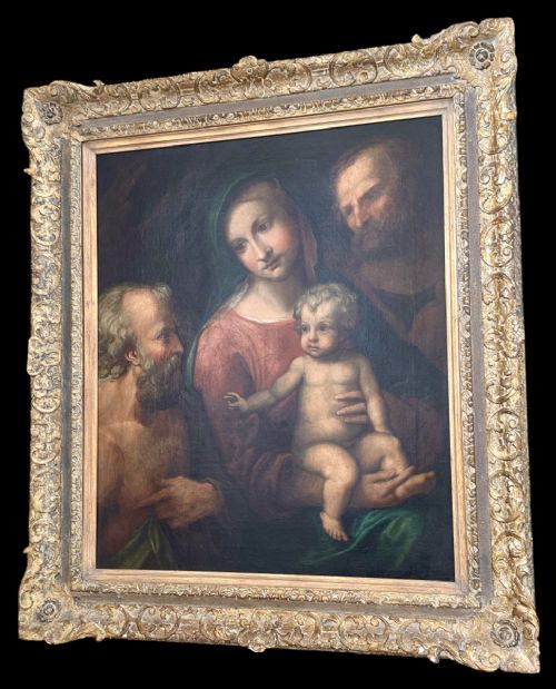 fig 4. An antique oil painting depicting the Holy Family with Saint Jerome set within an ornate carved gilded frame.
