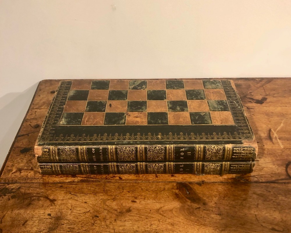 Two late nineteenth-century folding games boards fashioned as double-volume leather-bound books with gilt-tooled spines and chessboard playing tops. View V