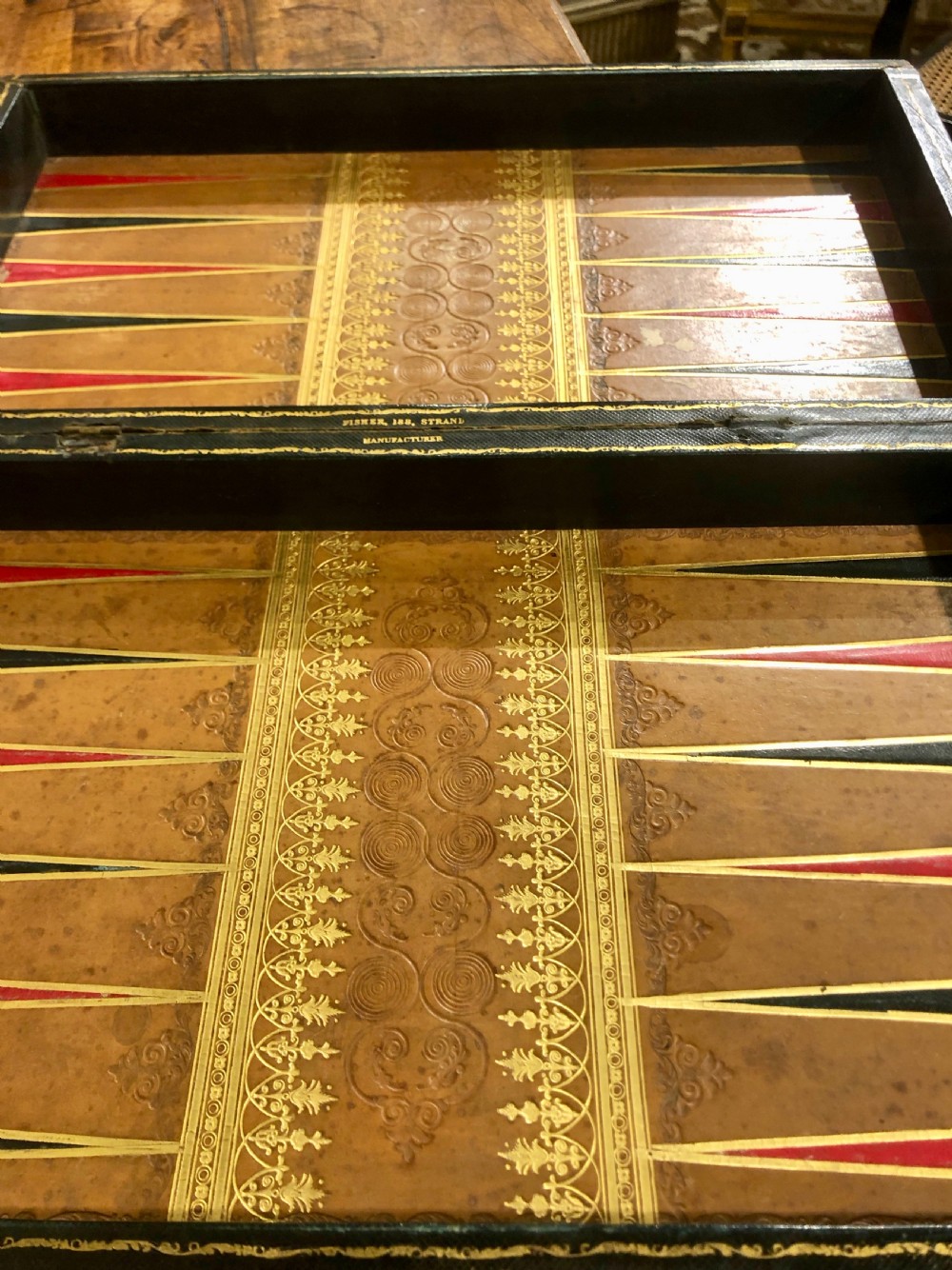 Two late nineteenth-century folding games boards fashioned as double-volume leather-bound books with gilt-tooled spines and chessboard playing tops. View VIII
